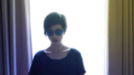 Cool hipster Asian woman wearing sunglasses for fashion shooting blur shot