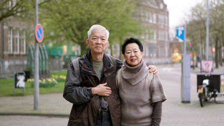 Asian senior couple traveling to Europe together gaining fun experience togetherの写真素材