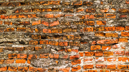 Old rustic brick and cracked plaster texture backgroundの写真素材