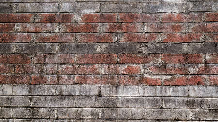 Old rustic brick and cracked plaster texture backgroundの写真素材