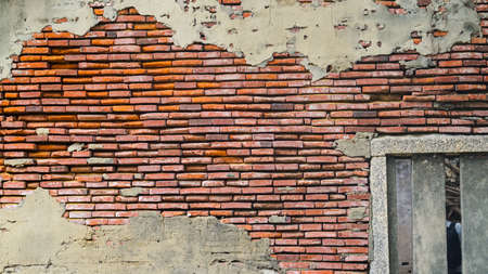 Old rustic brick and cracked plaster texture backgroundの写真素材