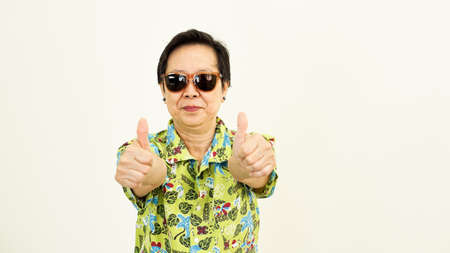 Healthy Asian senior woman looking forward for holiday travel tripの写真素材