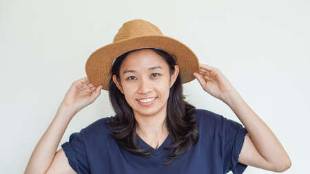 Casual Asian girl wearing straw hat summer fun. Relax and happy expressionの写真素材