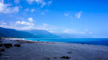 Hualien ocean of Taiwan. China. Beautiful blue sea with lush mountain and granite pebble beachの写真素材