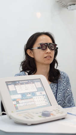 Asian woman test eyesight with optometrist for glassesの写真素材