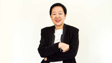 Asian senior woman wearing suit with happpy face and hand gestureの写真素材