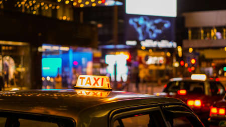 Taxi sign at night blur view in pub and bar nightlife area.の写真素材