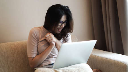Asian freelamce woman work at home with computer and success excite expressionの写真素材