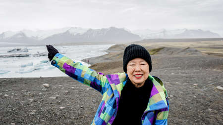 Asian senior woman travel to Iceland have fun after retirementの写真素材
