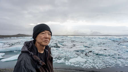 Asian senior man with Iceland glacier amazing viewの写真素材