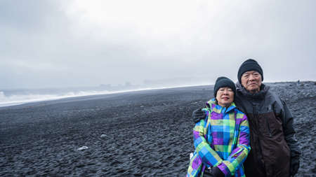 Iceland senior couple tourist at black beachの写真素材