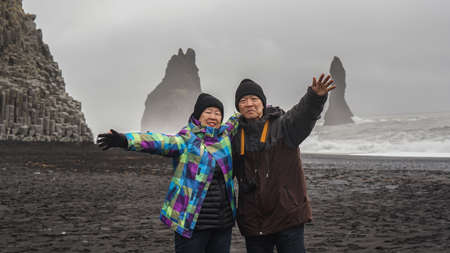 Iceland senior couple tourist at black beachの写真素材