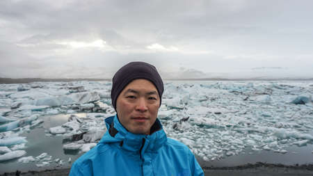 Asian man travel to Glacier lagoon in Iceland