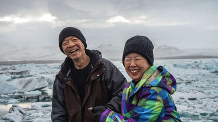 Asian senior couple fun trip in Iceland, majestic glacier lagoon landscapeの写真素材
