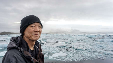 Asian senior man with Iceland glacier amazing viewの写真素材