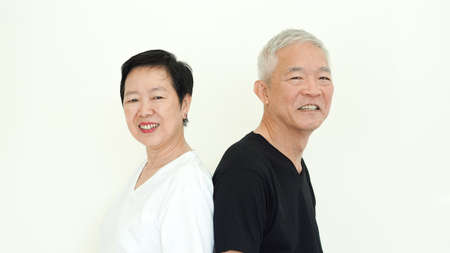 Asian senior couple smile together life with no worry on white backgroundの写真素材