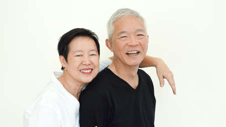 Asian senior couple smile together life with no worry on white backgroundの写真素材