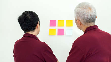 Asian senior couple checking on information white background copy spaceの写真素材