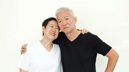 Asian senior couple smile together life with no worry on white backgroundの写真素材