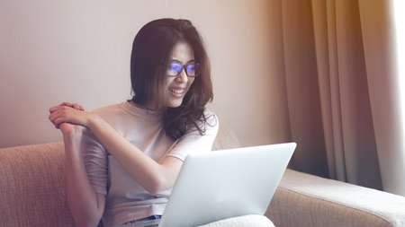 Asian freelance woman work at home with computer and success excite expressionの写真素材