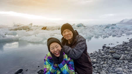 Asian senior couple fun trip in Iceland, majestic glacier lagoon landscapeの写真素材