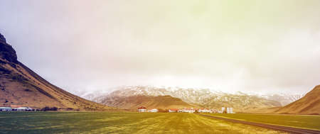 Iceland green landscape moss with mountain and cloudy skyの写真素材