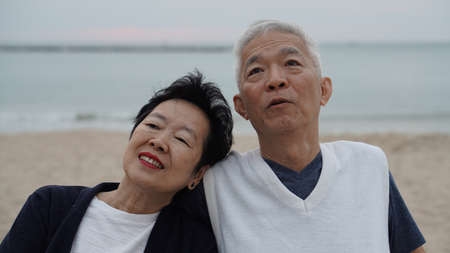 Asian senior couple enjoy their time together at the seaの写真素材