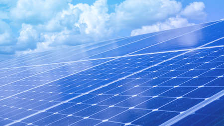 Renewable green energy power solar cell install on roof with sky reflectionの写真素材