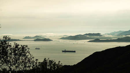 Aerial view of cargo ship heading to dock bayの写真素材