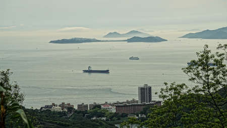 Aerial view of cargo ship heading to dock bay
