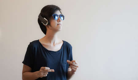 Asian woman hipster lifestyle using headphones and wearing eyeglassesの写真素材