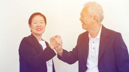 Asian senior business people couple holding hand for lifeの写真素材