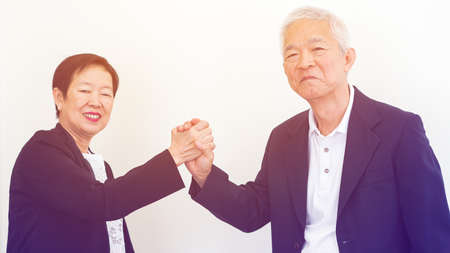 Asian senior business people couple holding hand for lifeの写真素材