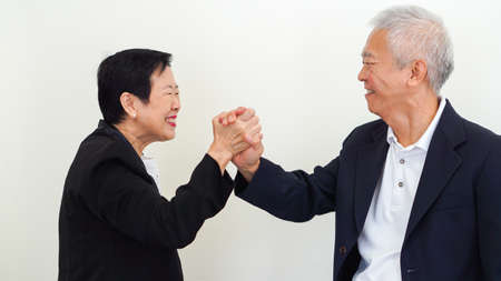 Asian senior business people couple holding hand for lifeの写真素材