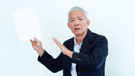 Asian senior businessman unhappy angry expression for result copy spaceの写真素材