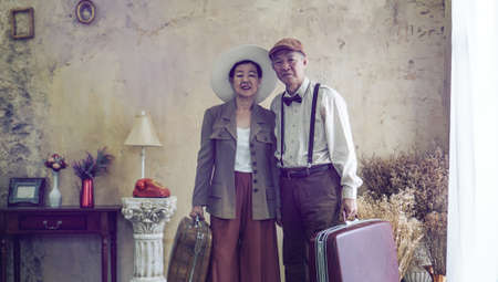 Vintage retro fashion Asian senior couple travel luxury trip after retirementの写真素材