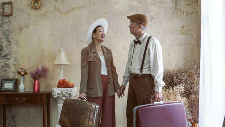 Vintage retro fashion Asian senior couple travel luxury trip after retirementの写真素材