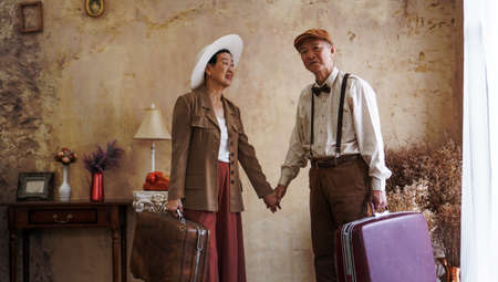 Vintage retro fashion Asian senior couple travel luxury trip after retirementの写真素材