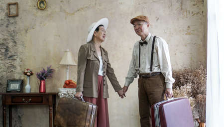 Vintage retro fashion Asian senior couple travel luxury trip after retirementの写真素材
