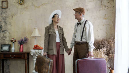 Vintage retro fashion Asian senior couple travel luxury trip after retirementの写真素材