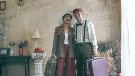Vintage retro fashion Asian senior couple travel luxury trip after retirementの写真素材