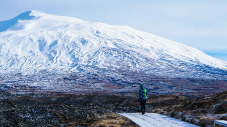 Tourist walk in Iceland volcanic landscape snow moutnian backgroundの写真素材