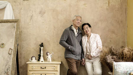Happy Asian senior couple casual dress with sunglasses in vintage style houseの写真素材