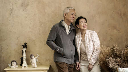Happy Asian senior couple casual dress with sunglasses in vintage style houseの写真素材