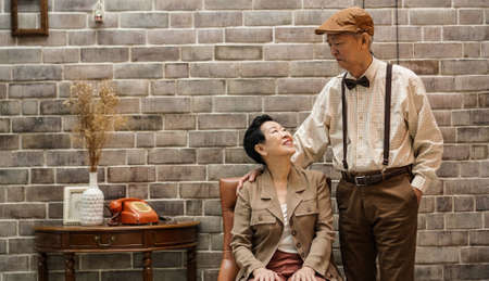Rich Asian senior couple vintage fashion in luxury homeの写真素材