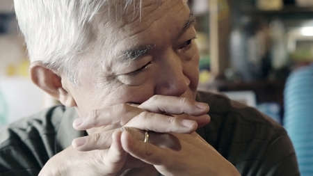 Asian senior elderly man with ring serious thinking and worry about futureの写真素材