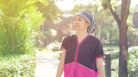 Asian ethnic woman with native dress smile at her mornign organic rice fieldの写真素材