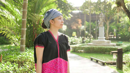 Asian ethnic woman with native dress smile at her mornign organic rice fieldの写真素材