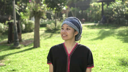 Asian ethnic woman with native dress smile at her mornign organic rice fieldの写真素材
