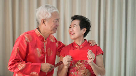 Asian senior Chinese new year red envelop happy festivalの写真素材